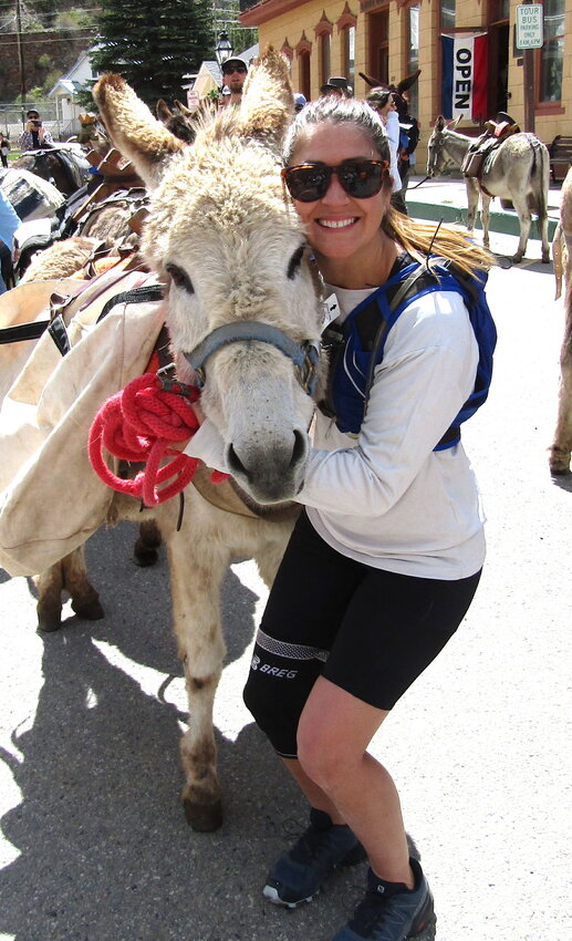 Nikki Ruelle of Georgetown poses with Thumper before the start of the burro race. This was Ruelle’s first time participating in the Georgetown tradition.